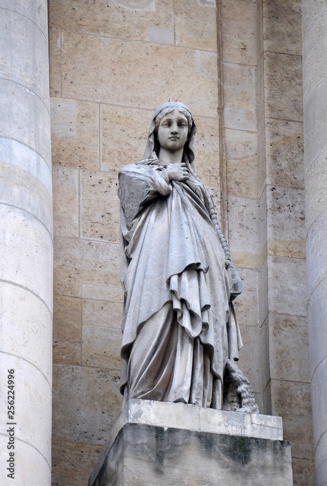 Saint Genevieve, statue on the portal of Saint Roch church in Paris, France 