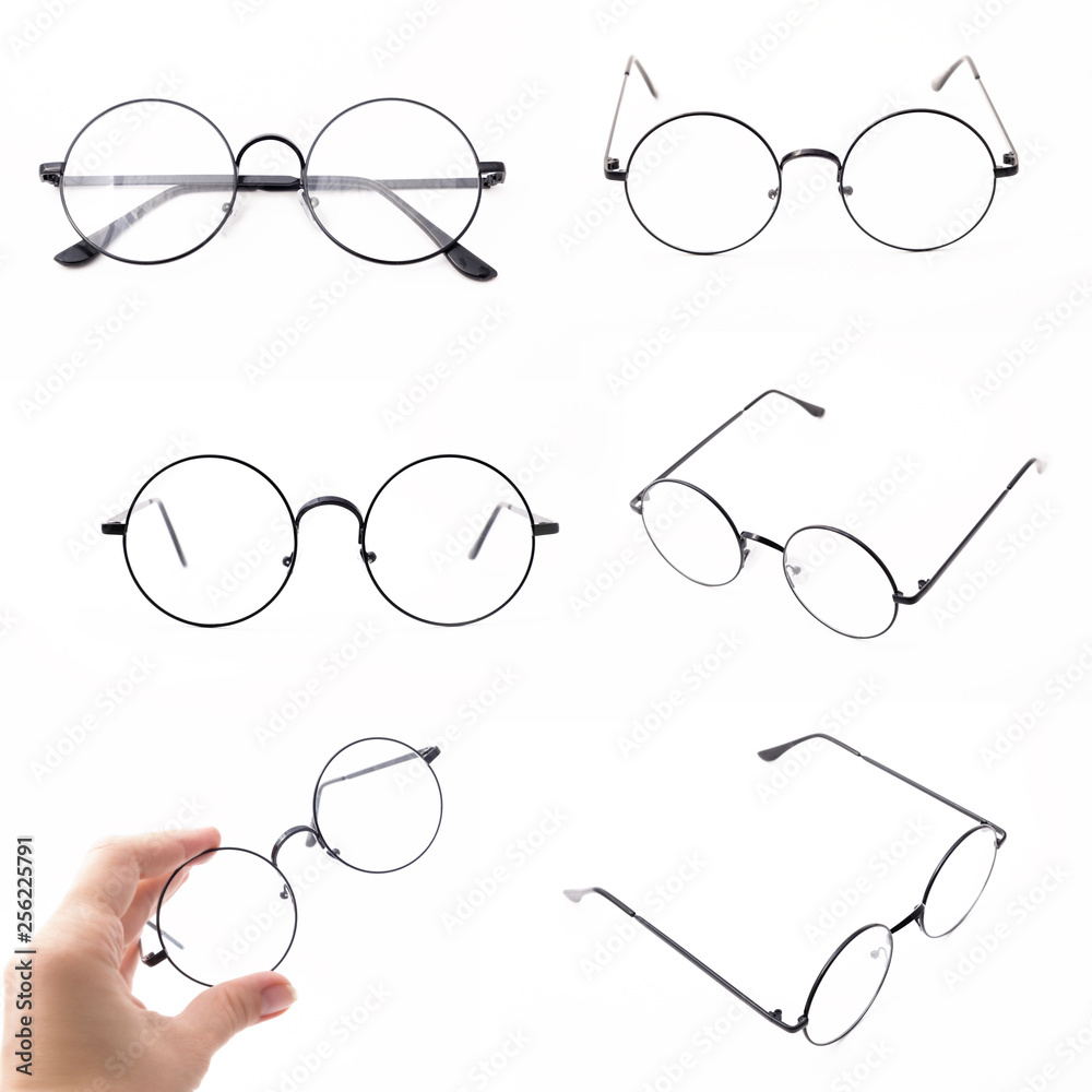 Set of round black-rimmed glasses are view from above. Hand holds glasses. Isolated on a light background. Set of round black-rimmed glasses are view from above. Hand holds glasses. Isolated on a light background.