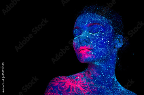 Picture of a pink jellyfish on the shoulder and face of the beautiful woman. ultraviolet body art