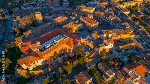 aerial view from a drone of an old rural town in italy at sunset