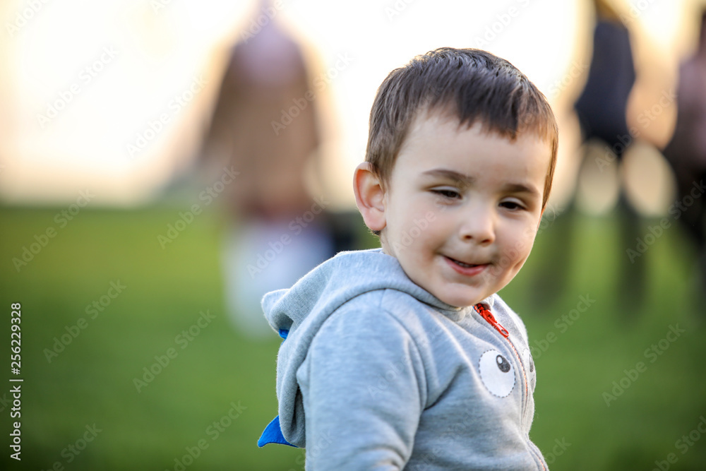 Cute baby playing with his on the grass Cute baby playing with his on the grass