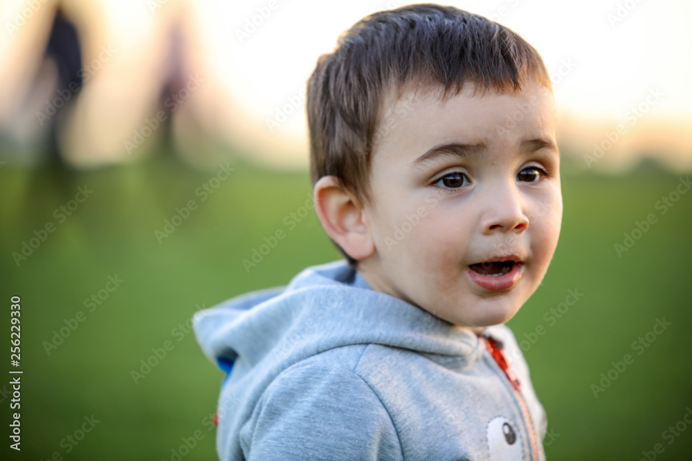 Cute baby playing with his on the grass Cute baby playing with his on the grass