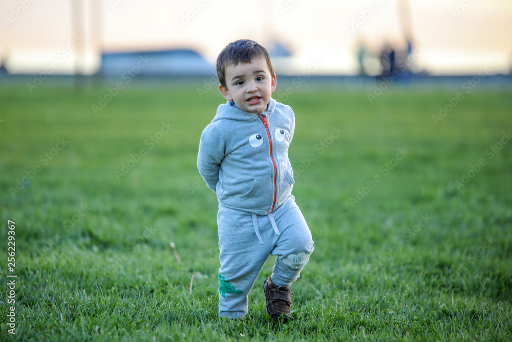 Cute baby playing with his on the grass Cute baby playing with his on the grass