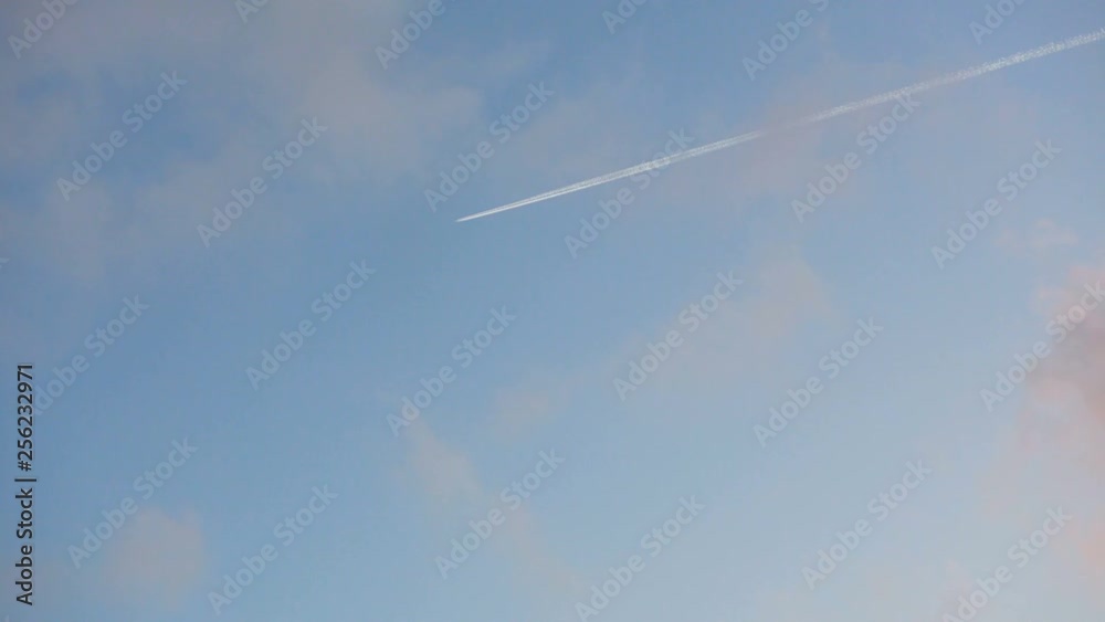 Flying jet airliner leaving contrain in the blue sky Flying jet airliner leaving contrain in the blue sky