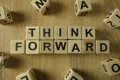 Think forward text from wooden blocks on desk