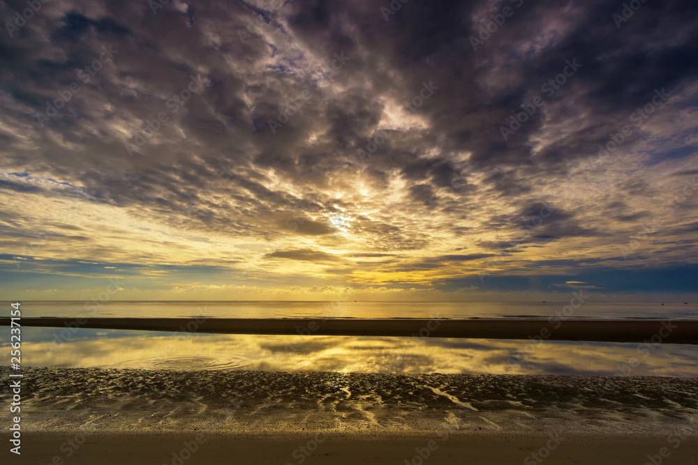 Beautiful tropical sea sky and sand reflection of a sunrise