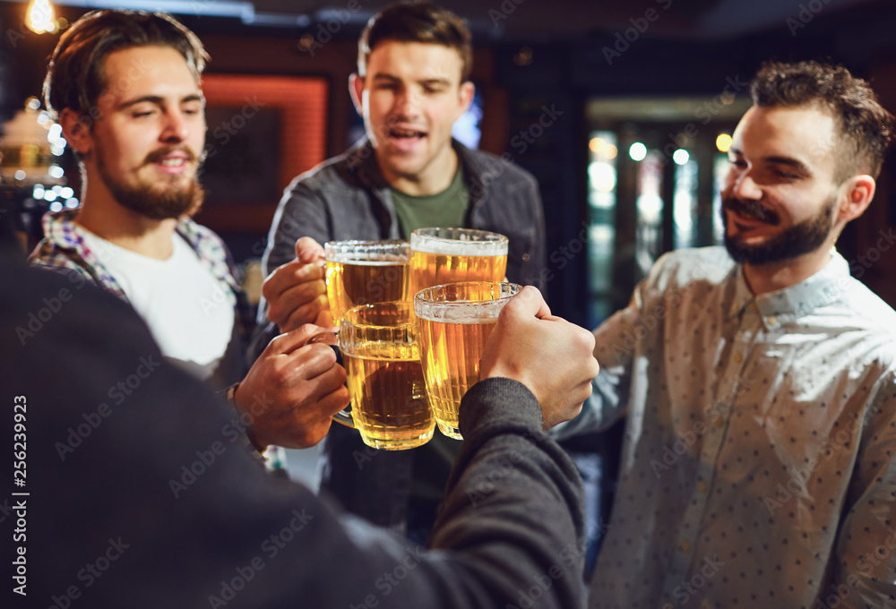 Friends have fun clincking glasses at the bar