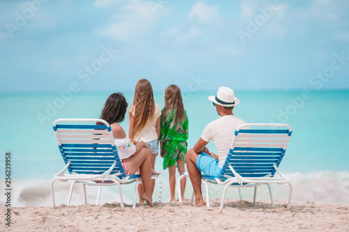 Happy beautiful family of four on the beach. © travnikovstudio