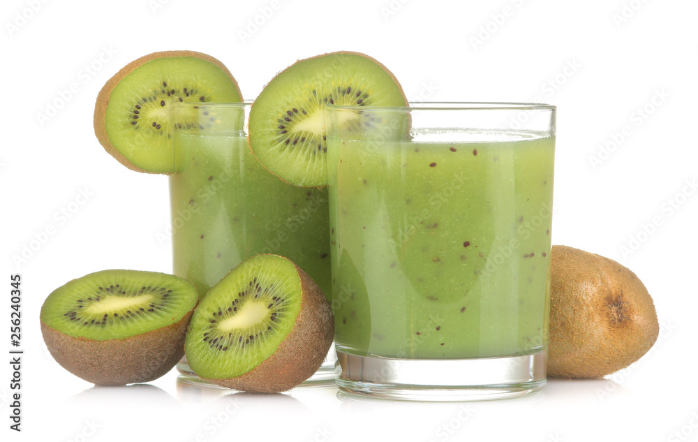 Kiwi smoothies in a glass next to fresh kiwi slices on a white isolated background. fruit drink. Kiwi smoothies in a glass next to fresh kiwi slices on a white isolated background. fruit drink.