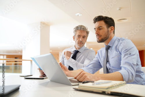 Male coworkers discussing business strategies