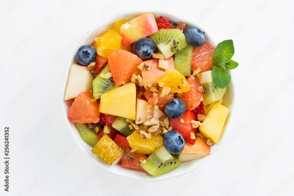 fresh fruit salad on white table, top view