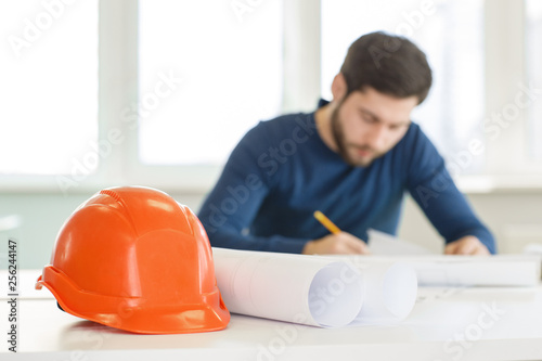 Young male architect working at his office