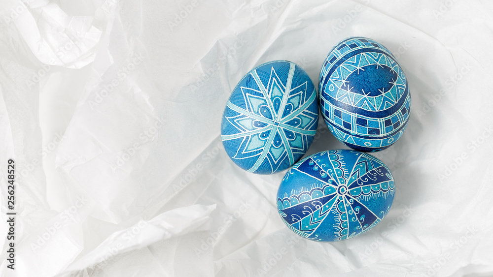Pysanky on the white crumpled paper background Stock Photo | Adobe Stock