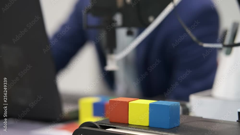 Learning the processes of robotics. Electronic engineer working in lab testing robotic program. Silhouette young scientist student in the laboratory. Education of the future and modern technologies