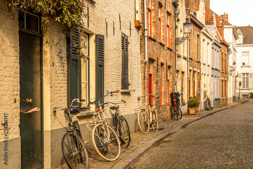 Bruges  Belgium - October 9  2014  Typical Belgian street and parked bicycles on foreground