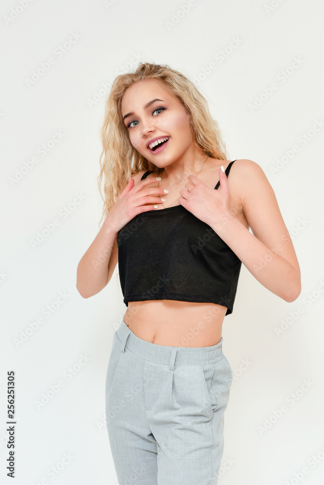 Photo of blond female model with white teeth looking at camera and smiling. Isolated on a white background