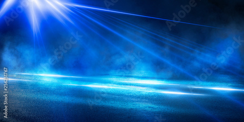Background of the room with concrete pavement. Blue and pink neon light. Smoke, fog, wet asphalt with reflection of lights. Abstract light, searchlight rays. Night view of the street with lights, dark © MiaStendal