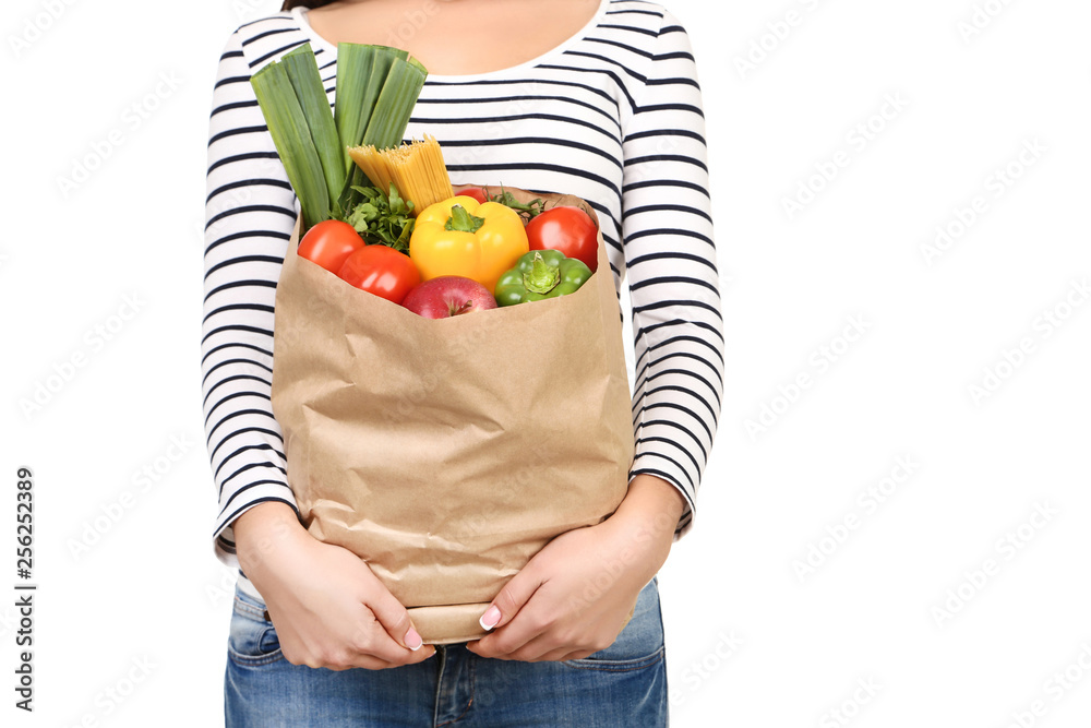 Woman holding grocery shopping bag on white background Woman holding grocery shopping bag on white background