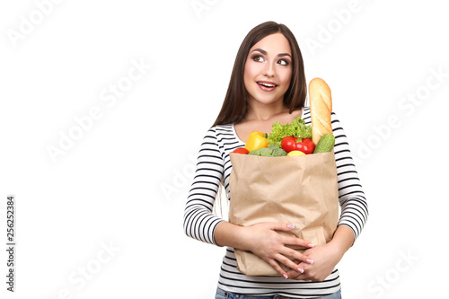 Beautiful woman holding grocery shopping bag on white background