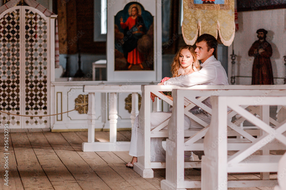 Bride and groom together in church. Horizontal photo