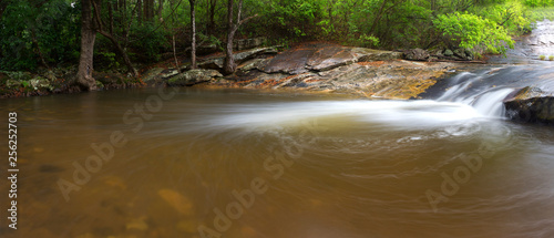 River flowing over rocks and the Debengeni Waterfall photo