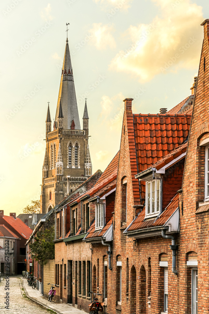 An old street in Bruges, with the Church of Our lady tower