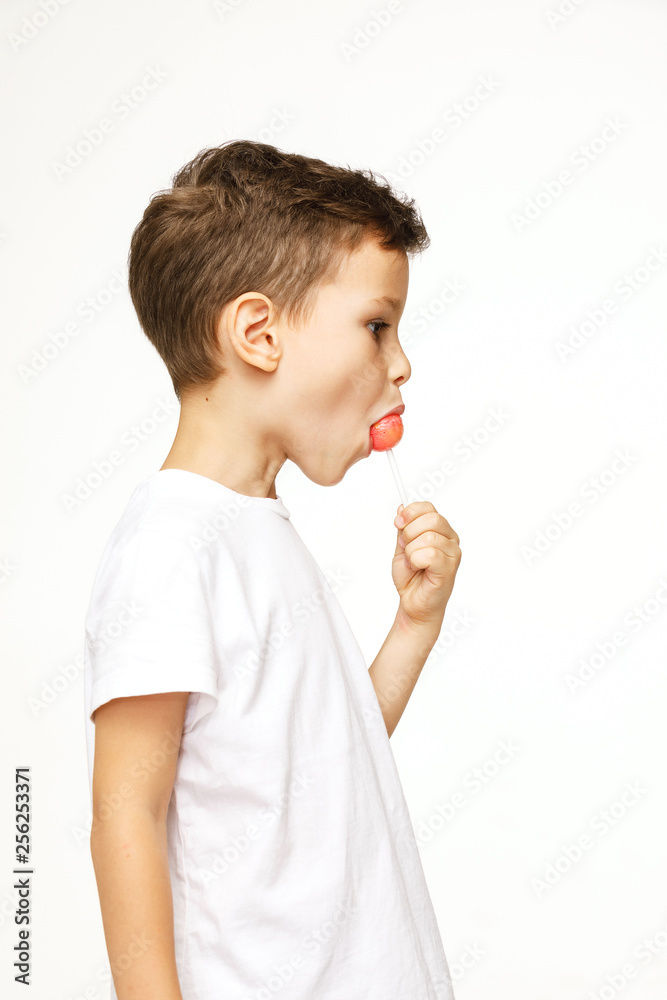 little boy with a lollipop on a white background 