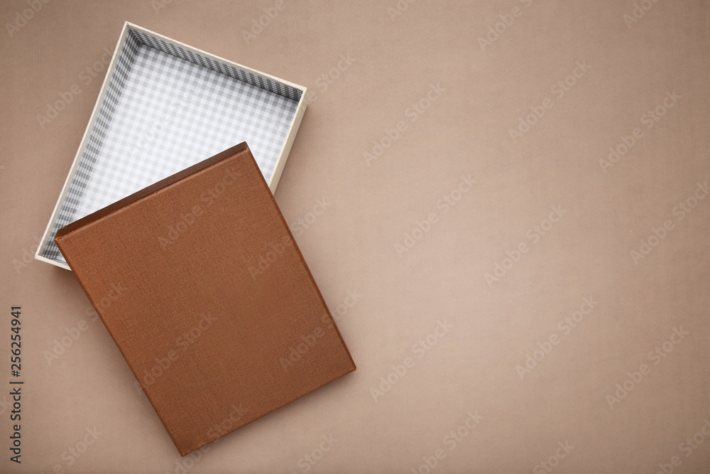 Fototapeta premium Open gift box on brown background