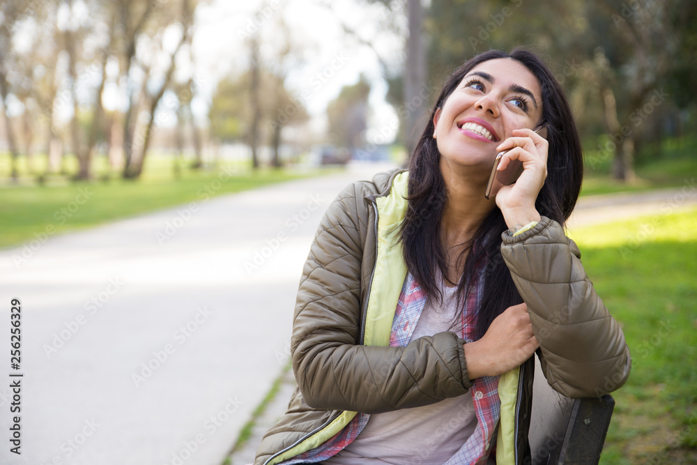Cheerful excited girl talking on mobile phone Cheerful excited girl talking on mobile phone