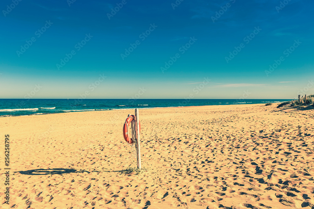 life preserver hanging on the lonely sandy beach life preserver hanging on the lonely sandy beach