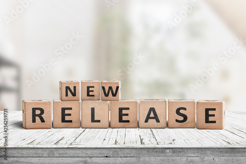 New release sign on a wooden table in a bright room photo