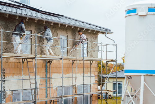 Plaster worker on scaffold working