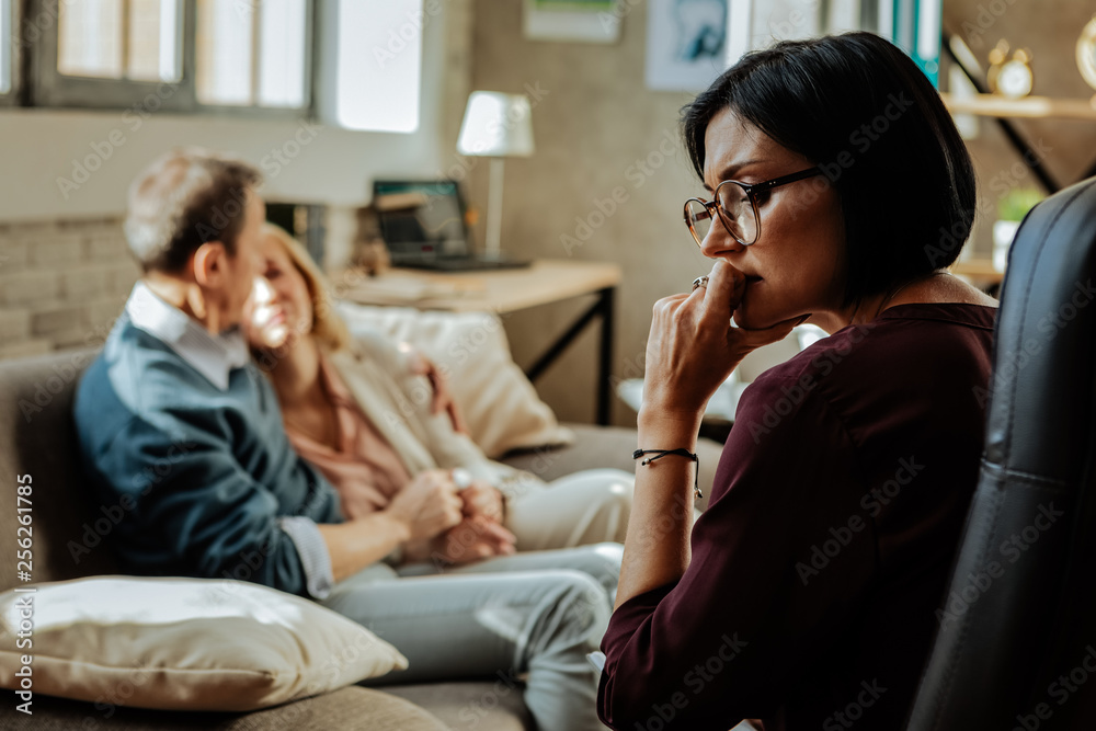Puzzled doctor with bob haircut thinking about situation in family