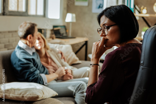 Puzzled doctor with bob haircut thinking about situation in family