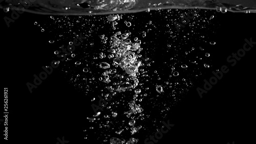 Blurry images of soda liquid water bubbles or carbonate drink or oil shape or beer fizzing or splashing and floating drop in black background for represent sparkling and refreshing