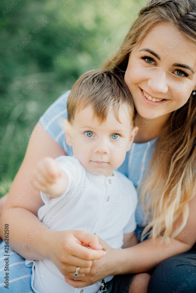 Happy young family spending time together outside in green nature