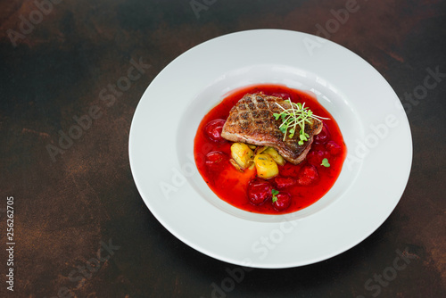 Steak from fillet of a duck with caramelized strawberry and an eggplant