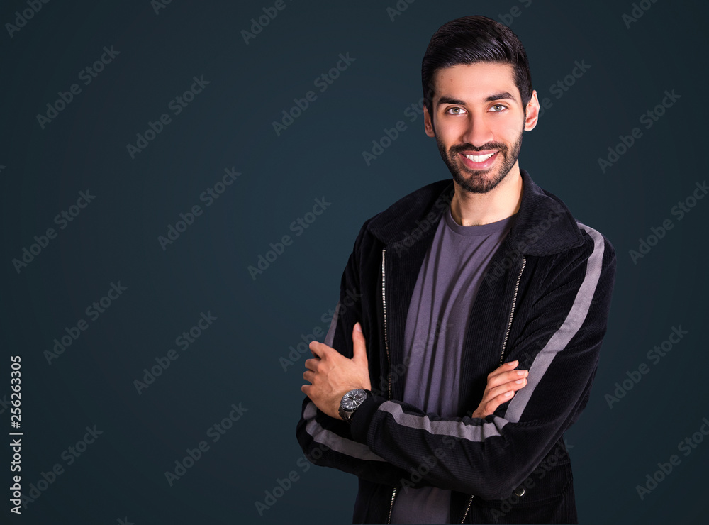 Handsome mixed race, south asian / indian looking man (model) wearing smart jacket and smiling - obrazy, fototapety, plakaty 