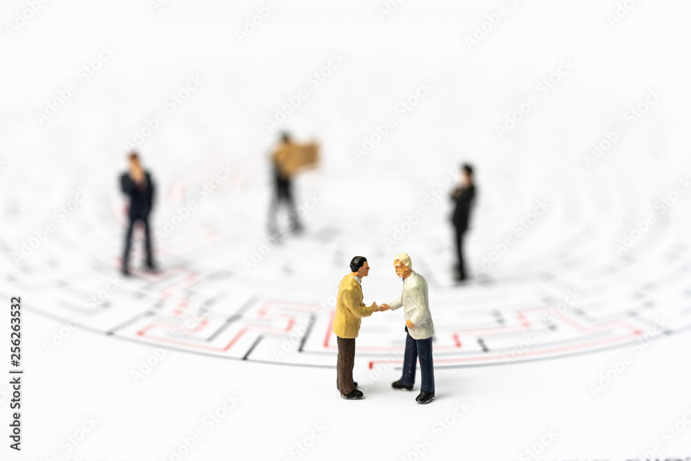 Miniature people, businessman in the labyrinth or maze figuring out the way out. Business concept, finding solution, strategic, and business opportunity. Miniature people, businessman in the labyrinth or maze figuring out the way out. Business concept, finding solution, strategic, and business opportunity.