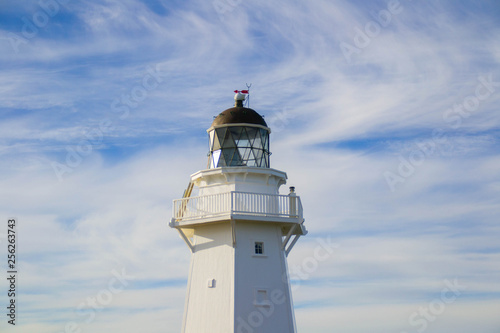 Travel New Zealand. Scenic view of white lighthouse on coast, ocean, outdoor background. Popular tourist attraction, Waipapa Point Lighthouse located at Southland, South Island. Travel concept.Catlins