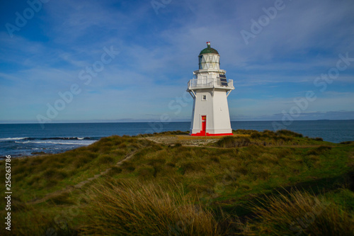 Travel New Zealand. Scenic view of white lighthouse on coast  ocean  outdoor background. Popular tourist attraction  Waipapa Point Lighthouse located at Southland  South Island. Travel concept.Catlins