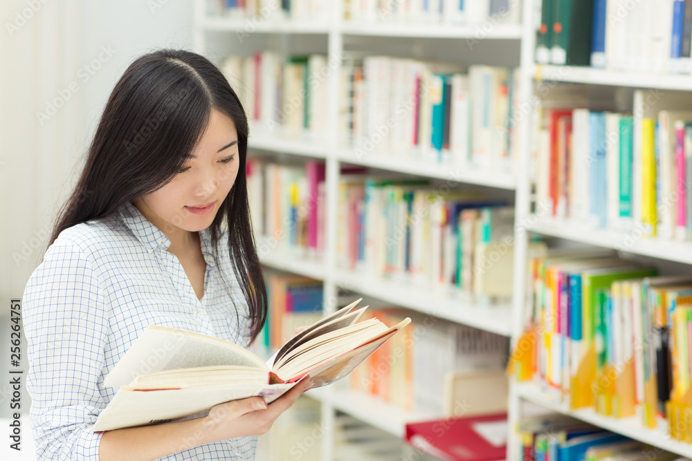 Young Asian female student at the library Young Asian female student at the library