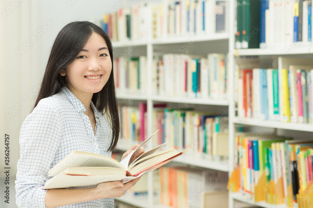 Young Asian female student at the library Young Asian female student at the library