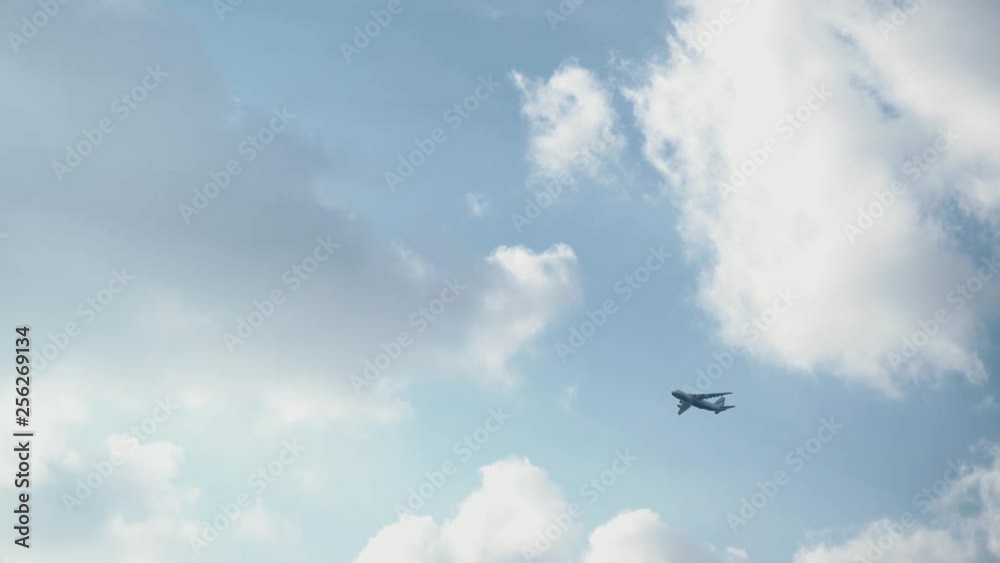 Passenger plane gaining height in the blue cloudy sky Passenger plane gaining height in the blue cloudy sky