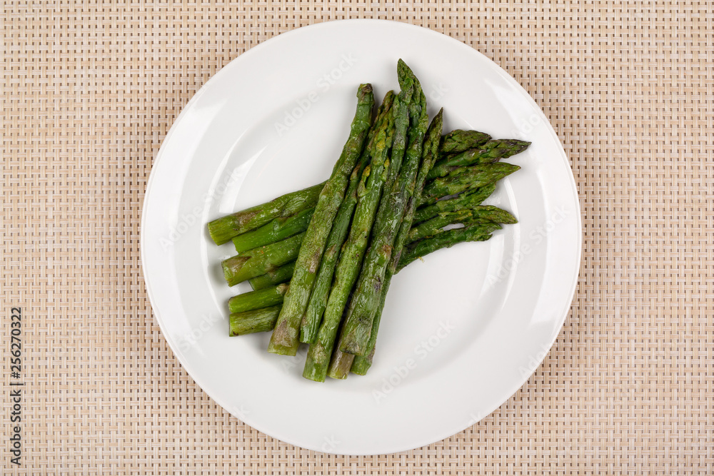 Green asparagus beans on a white round plate. Green asparagus beans on a white round plate.