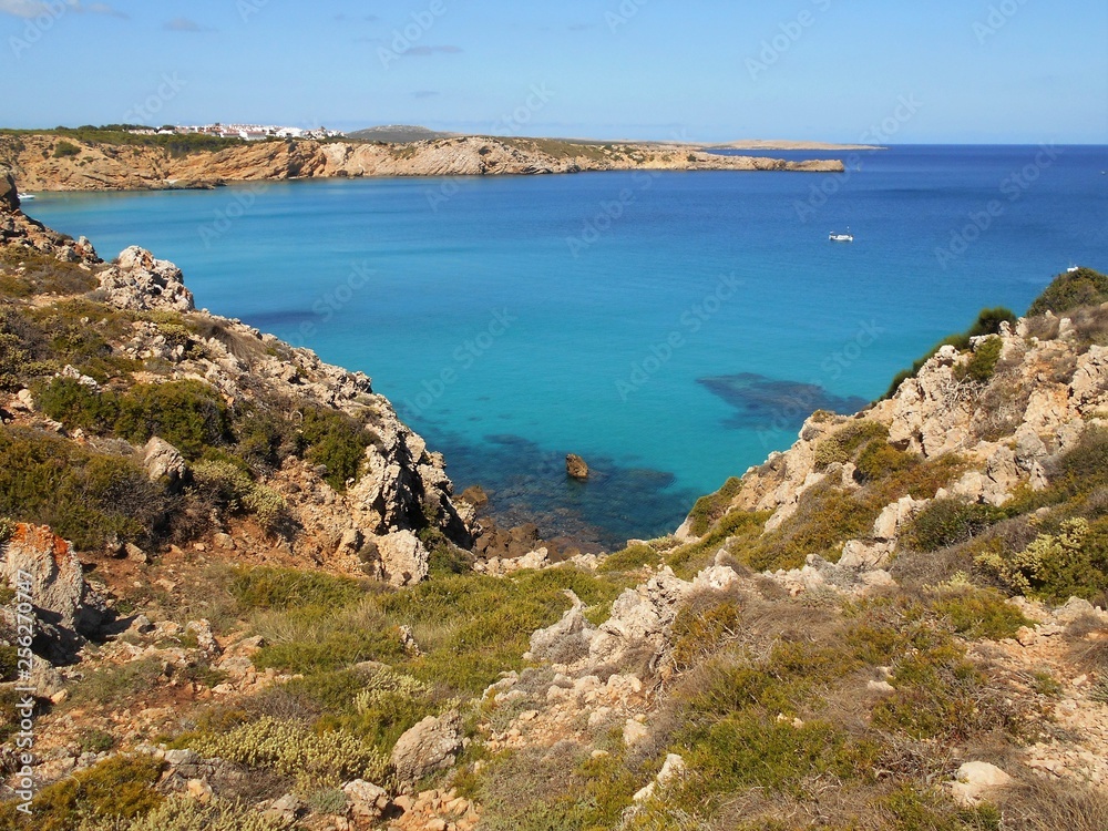 picture of the coast of the beautiful Menorca island in Spain. the mix of the green and blue colours of water and land create a beautiful natural effect. picture of the coast of the beautiful Menorca island in Spain. the mix of the green and blue colours of water and land create a beautiful natural effect.