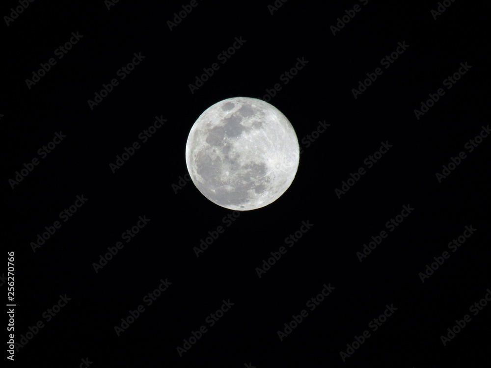 Beautiful bright full Moon in the night sky, lighting up all the colours below it Beautiful bright full Moon in the night sky, lighting up all the colours below it