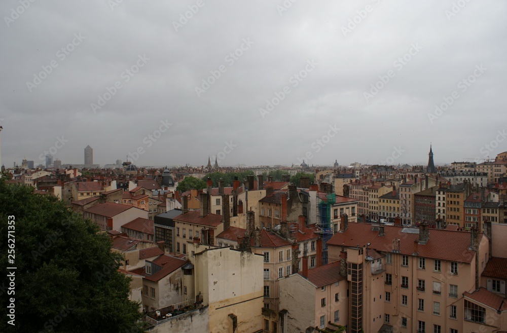 rooftops and view of the city on a rainy day, sunset in Lyon France