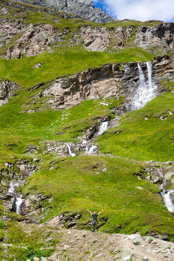 Fototapeta premium A young man at the alpine waterfall