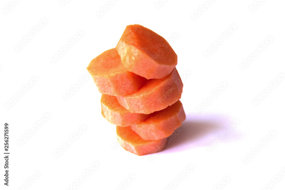 Tower of fresh carrot circles on a white background